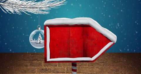 Christmas Arrow Sign with Snowy Bauble Background