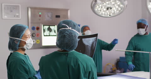 Surgeons Discussing X-ray in Surgical Operation Room