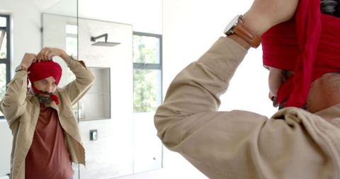 Man Adjusting Turban While Preparing in Modern Bathroom