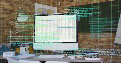 Displaying spreadsheet on central monitor with overlaid code grid in industrial office