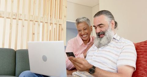 Smiling Couple Online Shopping from Comfort of Home