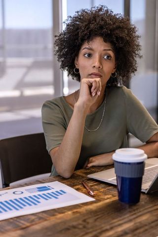 Contemplative Professional Analyzing Data in Modern Office