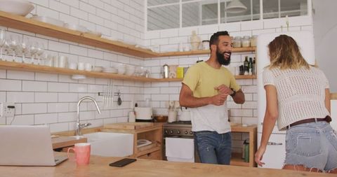 Couple Dancing Joyfully in Modern Kitchen at Home