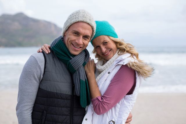 Portrait of mature couple standing together on the beach