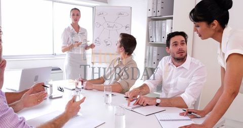 Business Team Engaging in Strategic Discussion Around Flip Chart