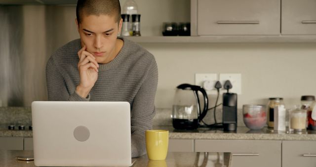 Young Man Working on Laptop in Modern Kitchen - Download Free Stock Images Pikwizard.com