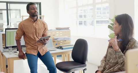 Diverse Workplace Discussion Between Colleagues for Effective Teamwork