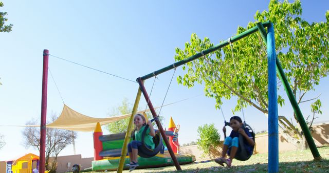 Children Swinging Playfully in a Park - Download Free Stock Images Pikwizard.com