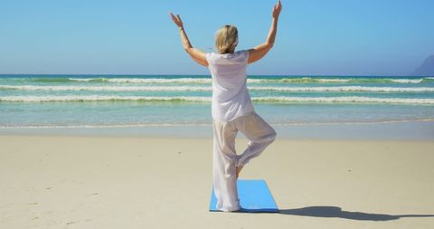 Senior Woman Practicing Yoga on Peaceful Beach - Download Free Stock Images Pikwizard.com