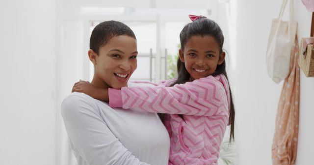 Smiling Mother Holding Daughter in Cozy Home Environment - Download Free Stock Images Pikwizard.com