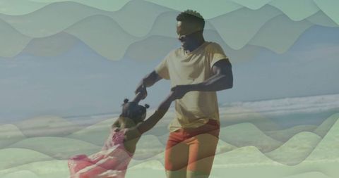 Joyful father and daughter playing by sunny beach