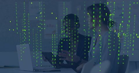 Two Women Collaborating over Laptop with Green Binary Code Overlay for Cybersecurity Team