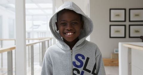 Smiling African American Boy Wearing Hoodie Indoors
