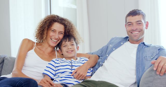 Happy Family Relaxing on Couch with Young Son Smiling - Download Free Stock Images Pikwizard.com