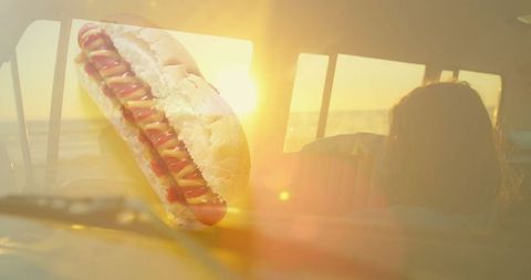 Floating Hot Dog in Retro Car During Golden Sunset