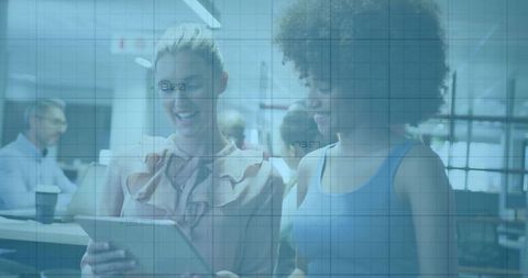 Two Colleagues Reviewing Tablet Content in Modern Open-Plan Office Collaboration