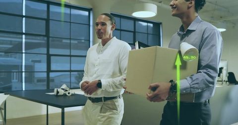Two colleagues carrying office moving box with lamp and ar analytics overlay in workspace