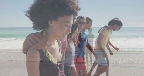 Joyful Friends Walking on Beach with Waves by Their Feet