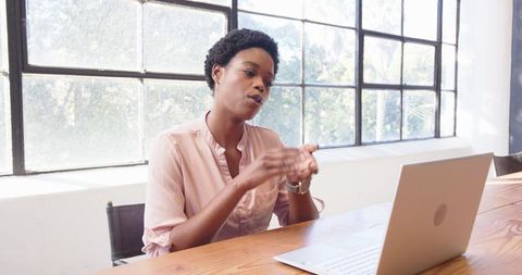 Professional Woman Engaged in Video Call Discussion
