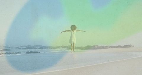 Woman in White Sundress Embracing Calm on Tranquil Beach