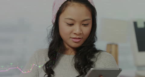 Young Businesswoman Analyzing Finance Graph using Tablet
