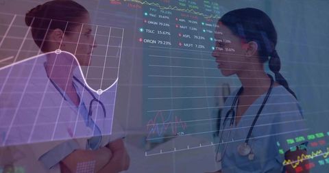 Female clinicians discussing medical data with mixed reality overlays in hospital corridor