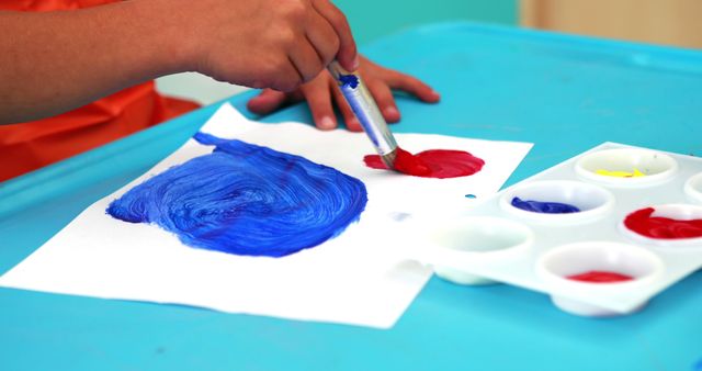 Child Painting with Brush on White Paper at Art Table - Download Free Stock Images Pikwizard.com