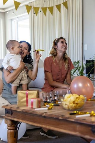 Joyful Family and Friends Celebrating Special Occasion in Cozy Living Room