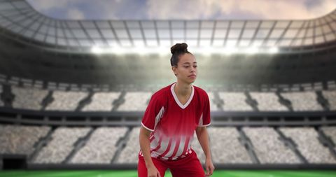 Determined Female Soccer Player Standing on Stadium Field
