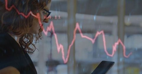 Businesswoman Analyzing Graph on Tablet in Modern Office