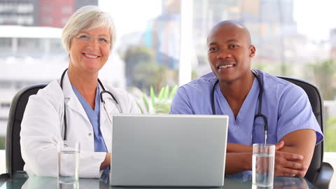 Healthcare Professionals in Collaborative Meeting at Office Desk