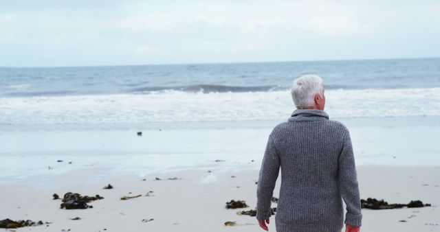Senior Man Enjoying Scenic Ocean View on a Tranquil Beach - Download Free Stock Images Pikwizard.com