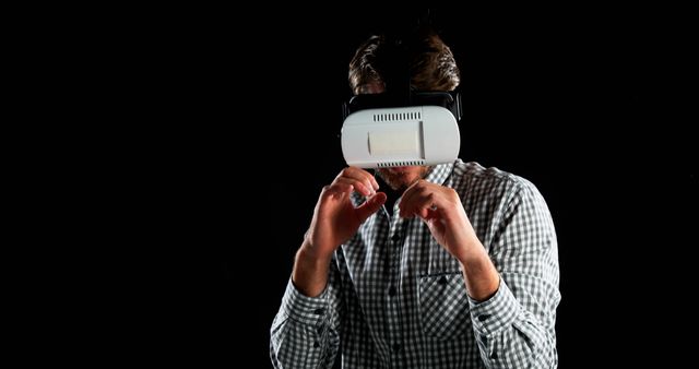 Man Experiencing Virtual Reality with VR Headset in Dark Background - Download Free Stock Images Pikwizard.com