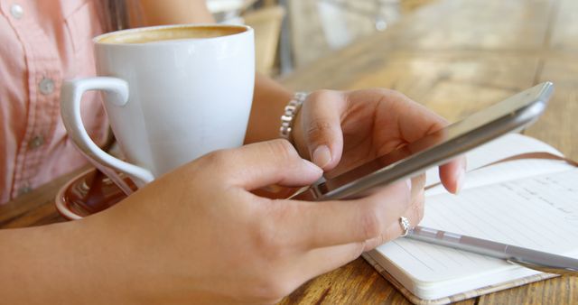 Close-Up of Hand Using Smartphone by Coffee Mug in Cafe - Download Free Stock Images Pikwizard.com