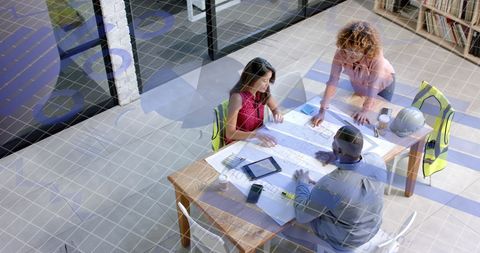 Architects Analyzing Blueprints in Modern Office with Digital Interface Overlay