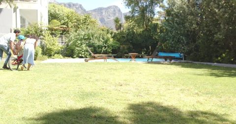 Family Teaching Child Ride Bike Sunlit Garden outdo Adventure