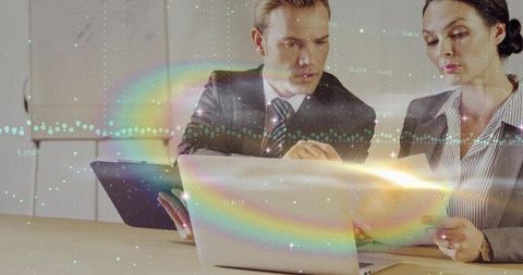 Business Professionals Analyzing Data Surrounded by Digital Charts