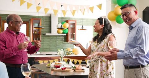 Joyful Seniors Celebrating Birthday with Food and Drinks at Home