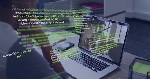 Developer Typing JavaScript Code on Laptop with Smartphone and Notes in Home Office