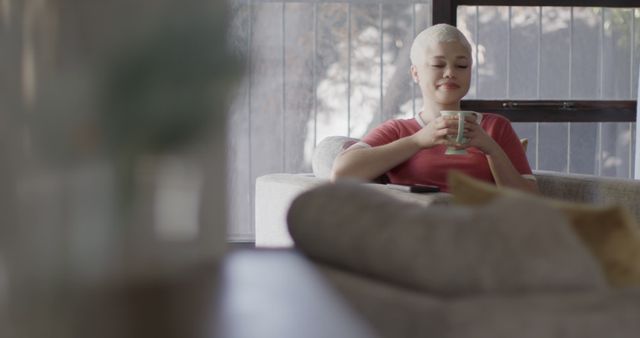 Smiling Woman Relaxing on Couch with Coffee at Home - Download Free Stock Images Pikwizard.com