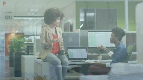 Businesswomen Discussing Work with City Animation Overlay