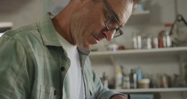 Concentrated Middle-aged Man Working in Home Workshop - Download Free Stock Images Pikwizard.com