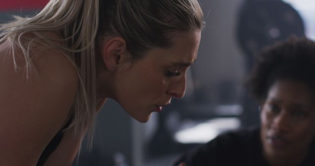 Image of diverse, exhausted woman and female fitness trainer talking after working out at a gym - Download Free Stock Photos Pikwizard.com