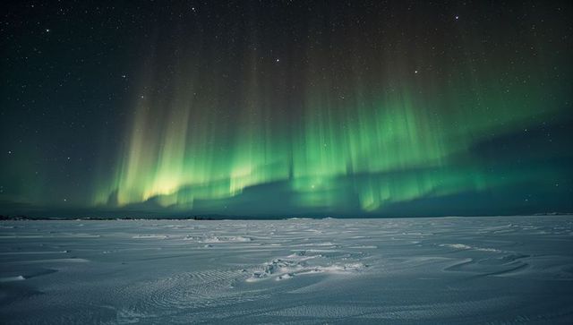 Aurora borealis dancing over frozen tundra with wind-swept snow and starry sky