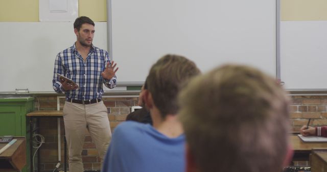 Male Teacher Giving Lesson to Attentive Students in Classroom Setting - Download Free Stock Images Pikwizard.com