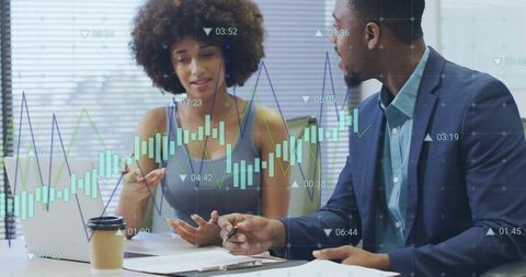 Diverse entrepreneurs examining financial data in office space