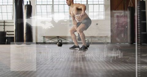 Shirtless man performing weighted hip hinge with kettlebells in industrial gym hud overlay