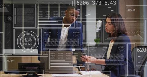 Discussing digital dashboards and analytics: professionals collaborating in modern office