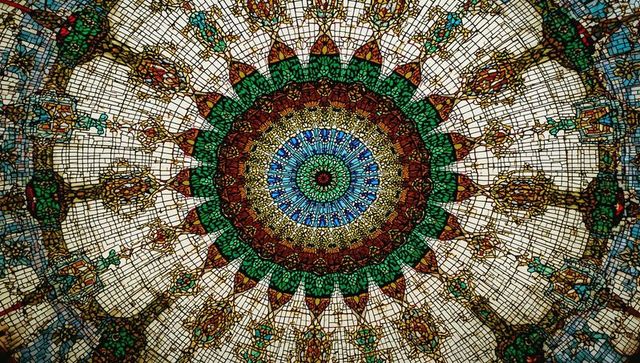 Ornate symmetrical stained glass dome interior view