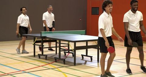 Diverse Friends Enjoying Ping Pong Game in Gym